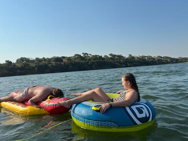 Guests enjoying water activities and boat tours at Lake Nhambavale